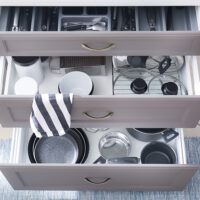 Set of clean kitchenware in drawers Set of clean kitchenware in drawers